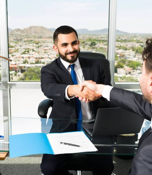 Happy welcome to the company business Businessman shaking hands with a company executive after making a lucrative business deal. Smiling sales representative making a successful sale